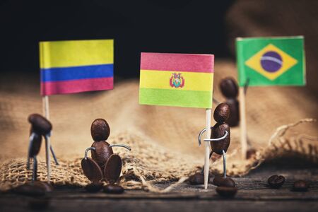 Coffee bean figures with the flags of some coffee producer nations like colombia, bolivia or brazilの写真素材