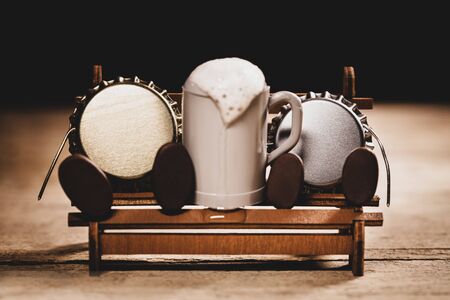 Crown cork or bottle caps miniature figures with a beer mug, humorous conceptual scene for beer and comfortの写真素材