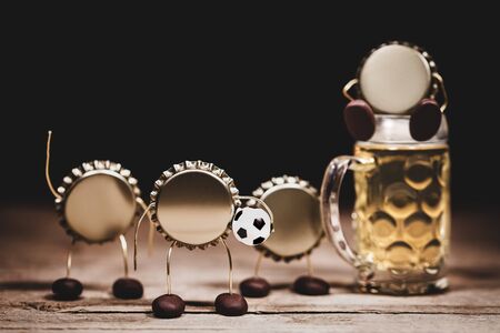 Crown cork or bottle caps miniature figures with a soccer football and a beer glass, hilarious...