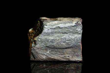 Copper schist, slate or shale ore, raw rock on black background, mining and geology, mineralogy