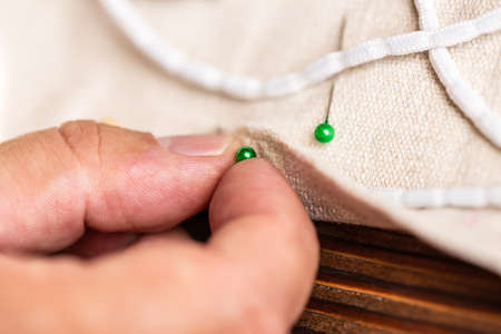 closeup from man hand with sewing needles or pins