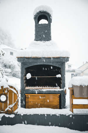 Waiting for the barbecue season, brazier covered with snow, winter and bbqの写真素材