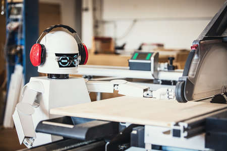 A robot works fully automatically in a carpentry workshop, robot autonomously performs various tasks in productionの写真素材