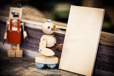 funny miniatures as carpenter working in a workshop, mini carpenters working diligently, funny concept for wood craftの写真素材