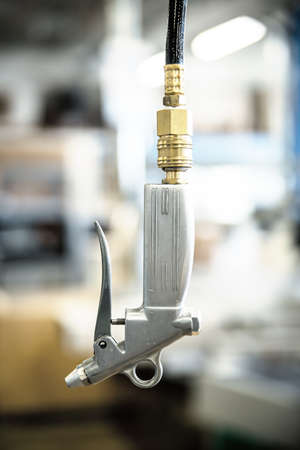 closeup of an air gun in a carpentry or workshop, air pistol in a warehouse