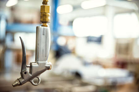 closeup of an air gun in a carpentry or workshop, air pistol in a warehouseの写真素材