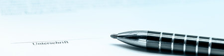 Banner or header, business concept picture with papers and documents, a pen and place to sign, German word Unterschrift which means signatureの写真素材
