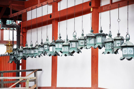 Suspended lanterns are lined up along the wall of a temple near Kyoto, Japanの写真素材