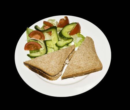 tuna sandwitch on brown bread with salad garnishの写真素材