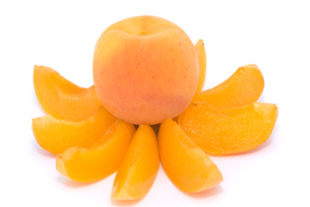 Whole ripe apricot on apricot slices on pure white backgroundの写真素材