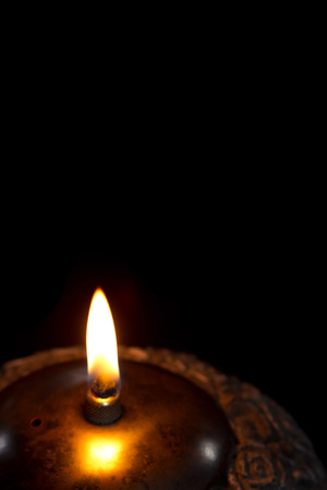 Single candle lantern on black background with flameの写真素材