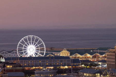 Night shot towards Cape Town waterfront showing big wheel and sea horizonの写真素材