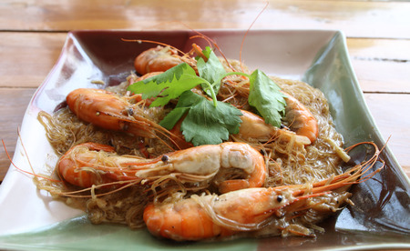 baked vermicelli with shrimp in plate on wooden backgroundの写真素材