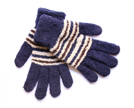 Warm woolen knitted gloves isolated on white background