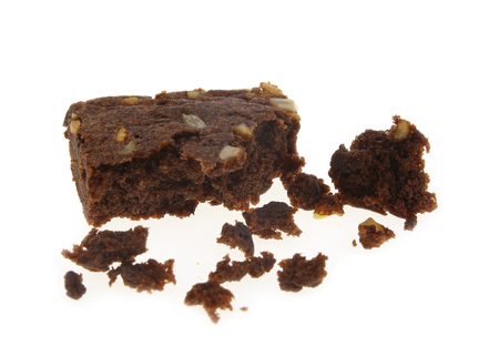 Chocolate brownie with bite-shaped chunk missing isolated on white background.の写真素材