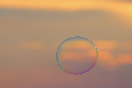 Soap bubbles floating in the air during sunset.