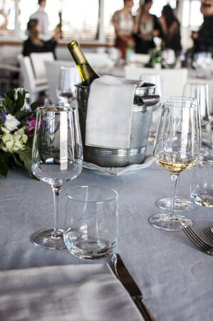 glasses and bottle of champagne in the background in a restaurantの写真素材
