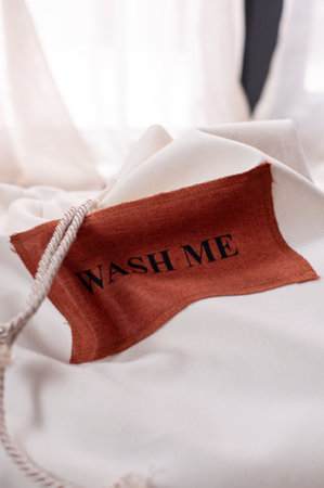 white laundry bag on chair with white background with text wash meの写真素材