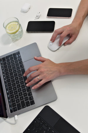 overhead view. Female hands working on modern laptop. office. white backgroundの写真素材