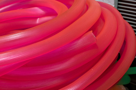 many long pink red plastic pipe for buildingの写真素材