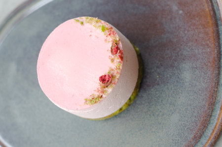 close up pink round cake on gray plate. top view.の写真素材