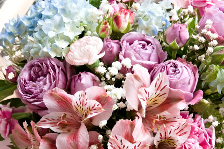 bouquet flowers, roses, lilies, and hydrangeas in pink, purple, and blue hues.