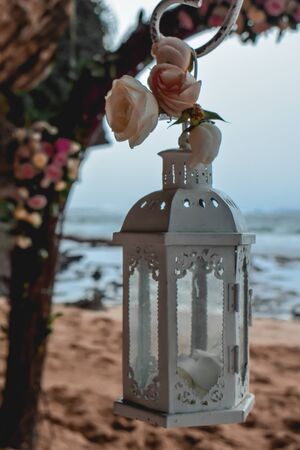 White lantern on a beach wedding decoration with wedding arch in Bali Indonesiaの写真素材