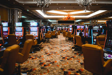 Video lottery terminals and gamblers inside the Venetian casino in Macau Chinaのeditorial素材