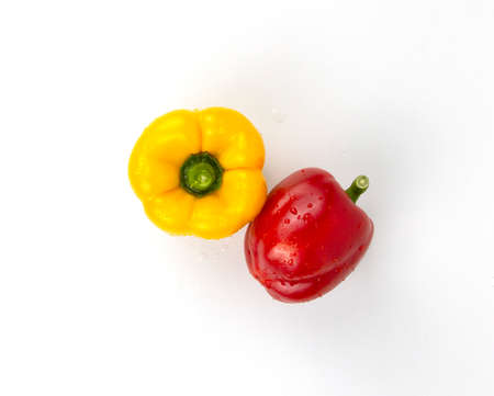 Red and yellow natural bell peppers isolated on white background. Healthy foods concept of meal, diet, fruits, chilis, yellow and redの写真素材