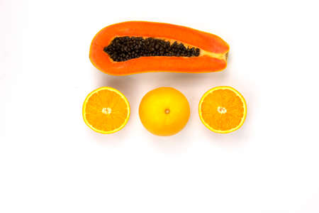 Arranging of Juicy Oranges cut isolated and a piece of papaya sliced arranged in the center of white...