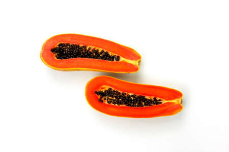 Two pieces of papaya slices isolated on white background, Fresh delicious papaya cuts in the center...