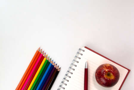 Education elements concepts, color pencils, face mask, paper clips, scissors, ruler, apple isolated on white background. Back to school conceptの写真素材