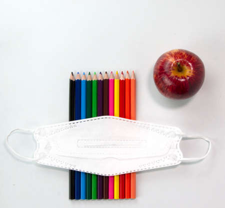 Education elements concepts, color pencils, face mask, paper clips, scissors, ruler, apple isolated...