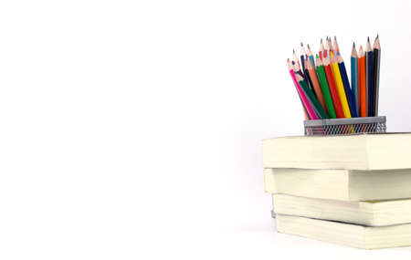 Education elements concepts, color pencils, face mask, paper clips, scissors, ruler, apple isolated on white background. Back to school conceptの写真素材