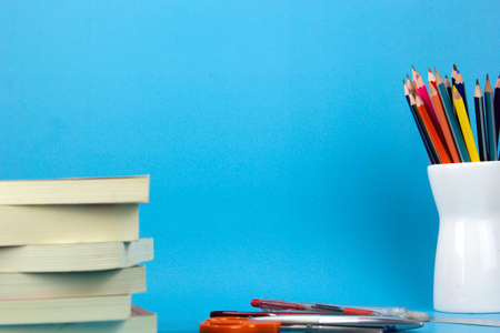 The isolated education elements books, pens, pencils on light blue background. used in Back to school poster, brochure templated design for education print adsの写真素材
