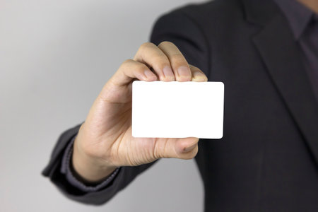 A Man holding white card, A Nice handsome man holding credit card on white backgroundの写真素材