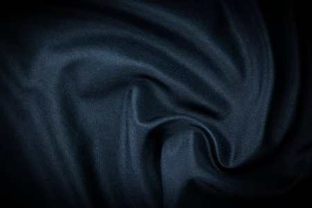 Dark blue fabric Texture blue, background, pattern. Texture of green silk fabric. Beautiful emerald soft silk cloth.の写真素材