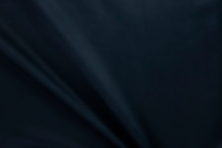 A dark blue fabric, clothes textile, wallpaper, fashion concepts of silk and cottons, Texture, background. template. Silk fabric blue, Blue silk drapery and upholstery fabric.の写真素材