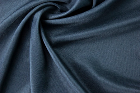 A dark blue fabric, clothes textile, wallpaper, fashion concepts of silk and cottons, Texture, background. template. Silk fabric blue, Blue silk drapery and upholstery fabric.の写真素材