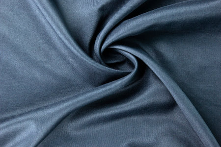 Dark blue fabric Texture blue, background, pattern. Texture of green silk fabric. Beautiful emerald soft silk cloth.の写真素材