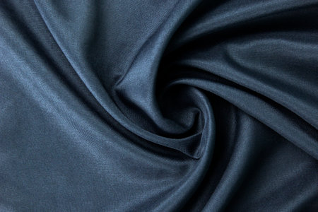 Dark blue fabric Texture blue, background, pattern. Texture of green silk fabric. Beautiful emerald soft silk cloth.の写真素材