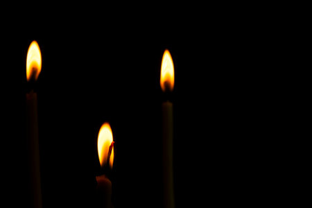 Three slim shape of Candle light of peace in the dark and yellow flame sue as peace elements, yoga.
