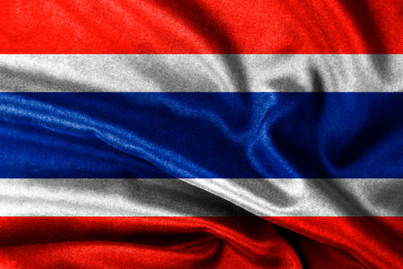 A Thailand flag blowing in the wind with highly detailed fabric texture designの写真素材