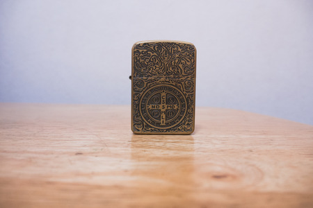 Constantine zippo lighter on a wood tableのeditorial素材