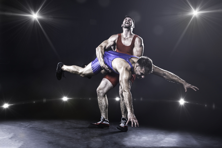 Wrestler throwing against the lights on background Wrestler throwing against the lights on background