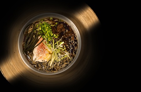 Japanese ramen noodle soup with chicken meat decorated with poached egg and green onion