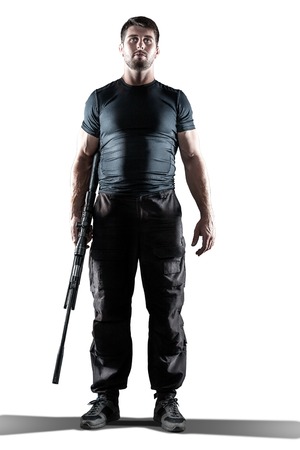 man in black military uniform holding rifle isolated on white backgroundの写真素材