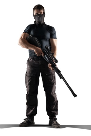 man in mask black military uniform holding rifle isolated on white backgroundの写真素材
