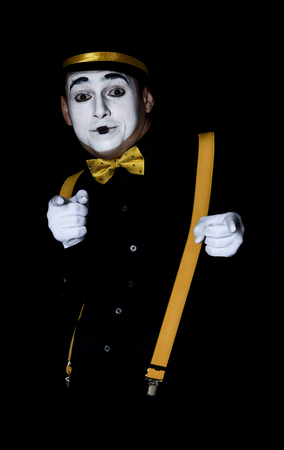 Male mime in black shirt and hat isolated on black backgroundの写真素材
