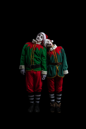 Couple of mimes in New Year costumes posing isolated on black backgroundの写真素材